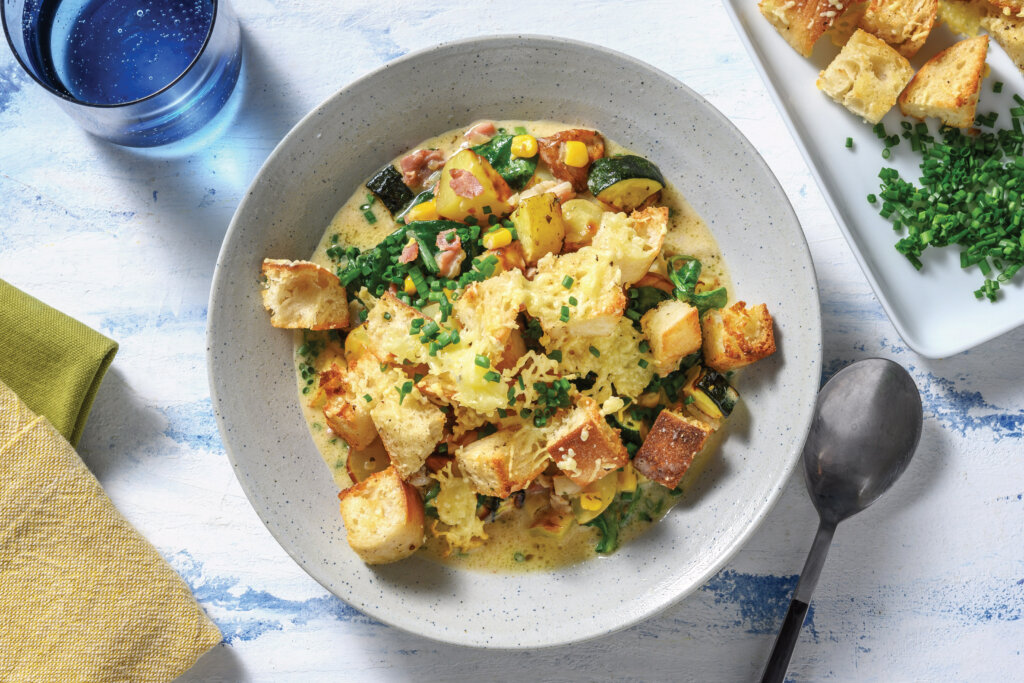 A comforting bowl of Creamy Bacon & Corn Soup with Kale & Cheesy Croutons