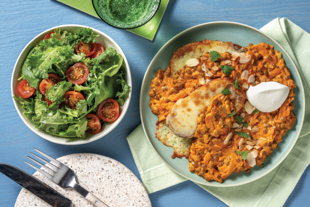 A hearty plate of Lentil Loaded Spuds & Tomato-Kale Salad