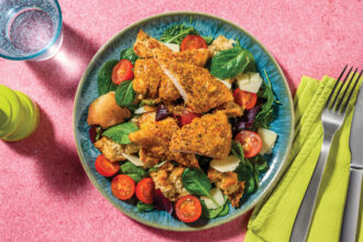 A blue bowl filled with panzanella style salad